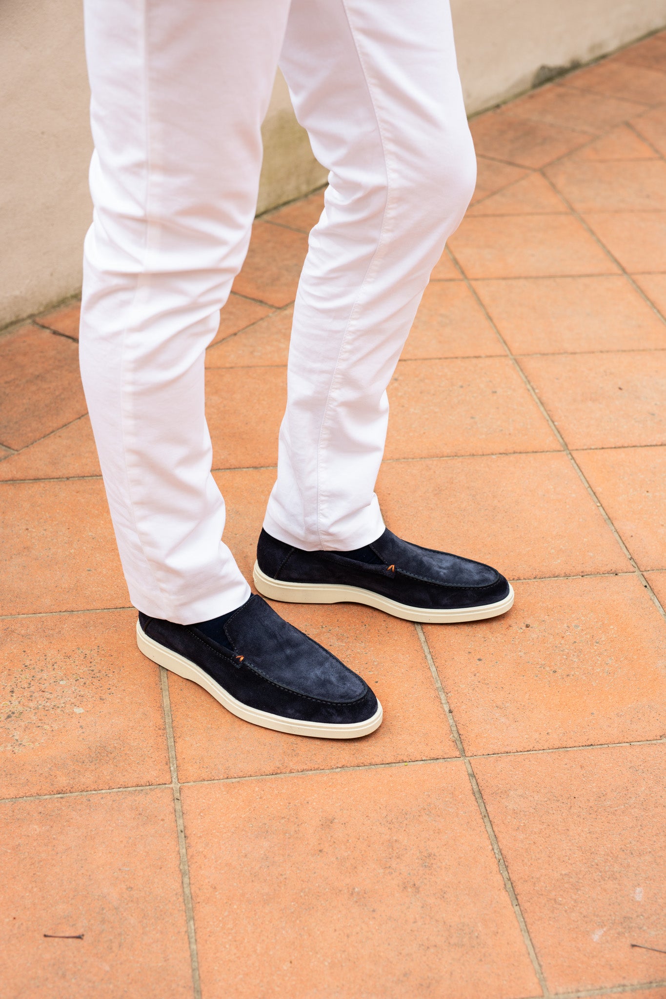 white trousers and navy suede loafer