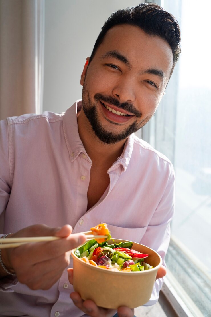 medium-shot-man-eating-salmon-bowl_23-2150533974.jpg